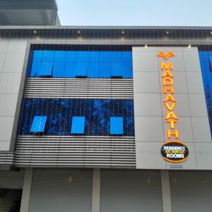 a building with a sign on the side of it at MADAVATH RESIDENCY in Kenichira