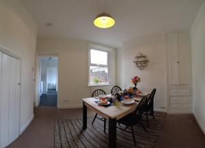 a dining room with a table and chairs at 2-bed terraced home - 5 min walk to the City Walls in York