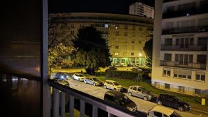 a group of cars parked in a parking lot at night at Escapade Mulhousienne in Mulhouse