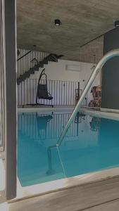 a swimming pool with a stairway and a slide at las tunas in Funes