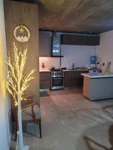 a kitchen with a tree in the middle of it at las tunas in Funes