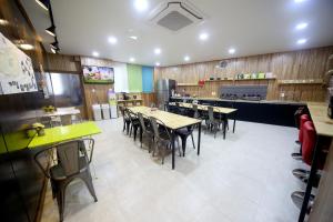 a dining room with tables and chairs in a restaurant at Ganse Guesthouse in Jeju