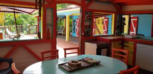 a kitchen and dining area of a house with a table at KANOUAN in Deshaies