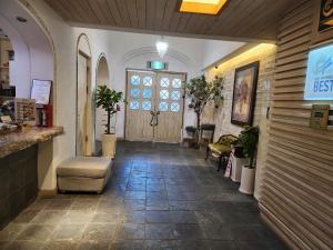 a corridor of a store with a lobby with a door at Asan Paradise in Asan