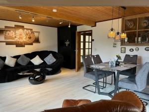 a living room with a table and a couch at Ferienhaus 33 Altmühlthal in Kinding