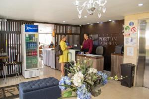 萨瓦内塔Hotel Portón Sabaneta的两个人站在商店的柜台上