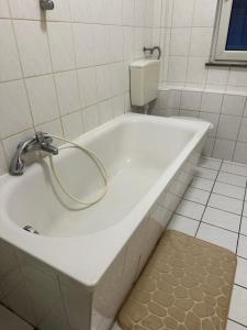 a bath tub with a hose in a bathroom at 2 Zimmer mit 4 Betten (Wohnung Apartment) in Bruchsal