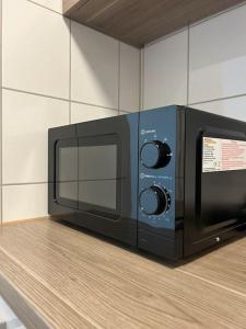 a black microwave sitting on top of a counter at Sonnenschein-Oase ,Apartment in Marl