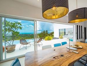 a dining room with a table and a view of the ocean at 25% OFF! 7 min to Chaweng beach in Nathon Bay