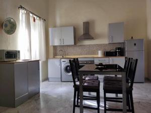 a kitchen with a table and chairs in a kitchen at Apartamentos JP Fregenal in Fregenal de la Sierra