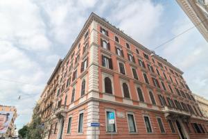 a large brick building on a city street at Luxury apartment near via veneto in Rome