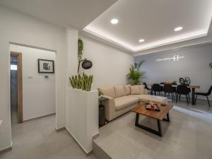 a living room with a couch and a table at ELiXiR 1 Luxury apartments in Agios Nikolaos