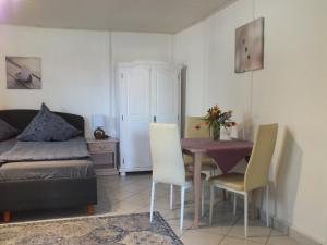 a room with a table and chairs and a bed at Ferienpark Buntspecht Bungalow 7 in Pruchten