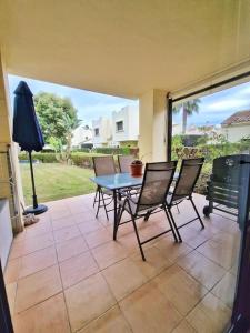 a patio with a table and chairs on a porch at Apto. Residencial Poniente en San Javier in San Javier