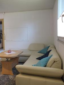 a living room with a couch and a table at Ferienpark Buntspecht Bungalow 7 in Pruchten