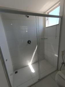 a shower with a glass door in a bathroom at Trip Hotel Ubá in Ubá