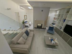 a large living room with a couch and a table at Golden Suite Apartments in Matera