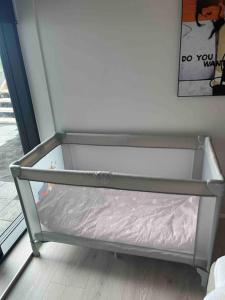 a metal bed frame in a room next to a window at New apartment in the capital region in Garðabær