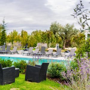 a yard with chairs and a swimming pool at Hôtel Dali Val d'Europe in Chanteloup-en-Brie
