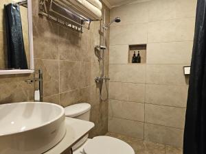 a bathroom with a shower and a toilet and a sink at LVM Bodufolhudhoo in Bodufolhudhoo +71 photos