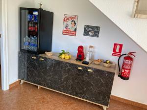 a black cabinet in a room with a drink refrigerator at Luarca Zabala in Luarca