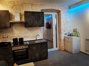 a kitchen with a sink and a counter top at Deluxe in Alberobello