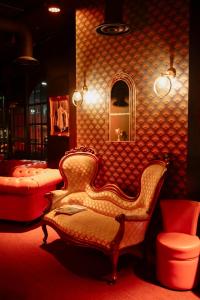 - un salon avec une chaise et un miroir dans l'établissement Hôtel Dali Val d'Europe, à Chanteloup-en-Brie