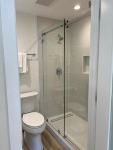 a bathroom with a toilet and a glass shower at One room with one queen bed studio to rent in Palo Alto