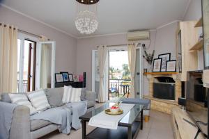 a living room with a couch and a table at Old Harbour Aroura 2BR Home in Spetses