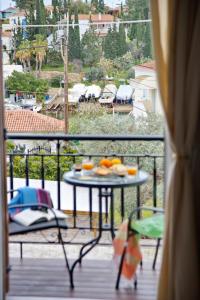 a view of a balcony with a table with fruit on it at Old Harbour Aroura 2BR Home in Spetses