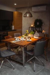 a wooden dining room table with chairs in a kitchen at Apartmany pod Pustevnami in Prostřední Bečva