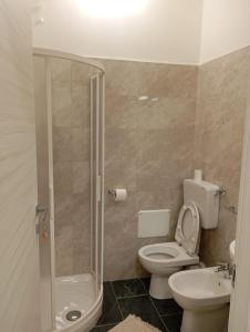 a bathroom with a shower and a toilet and a sink at CASAGRANDE - GUEST HOUSE in Livorno