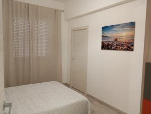 a bedroom with a bed and a painting on the wall at CASAGRANDE - GUEST HOUSE in Livorno