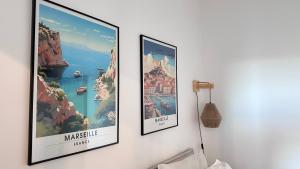 three framed pictures hanging on a wall at Perla de la Canebière-5min à pieds du vieux-port in Marseille