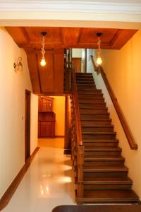 a staircase in a house with wooden ceilings at Silver Homes Homestay in Alwaye