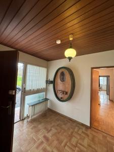 een woonkamer met een houten plafond en een spiegel bij Haus mit Pool und Panoramablick in Hirschaid