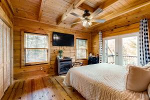 a bedroom with a bed and a flat screen tv at Lost Indian Hideaway in Whittier