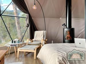 a bedroom with a tent with a bed and a fireplace at Dome in Nature in Larnaka