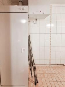 a kitchen with a white refrigerator in a room at Party condo in the center of Levi in Levi