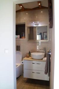 a bathroom with a white sink and a toilet at Olive Hill in Žrnovo