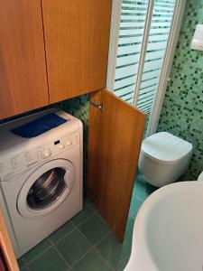 a bathroom with a washing machine and a toilet at MARCONI APARTMENTS in Termoli +75 photos