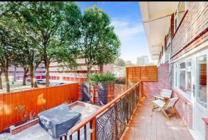 - un balcon avec une table et des chaises dans un bâtiment dans l'établissement Newly renovated 4BR in Kings Cross with Garden, à Londres