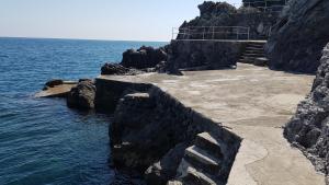 un sentiero in pietra vicino all'oceano su una scogliera di Amalfi Blu Paradise ad Amalfi