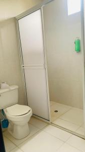een witte badkamer met een toilet en een douche bij HOSTAL MARIA ISABEL in Santa Marta