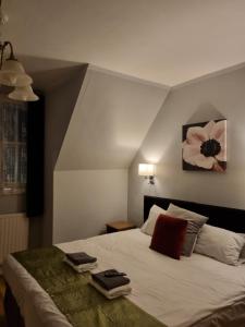 a bedroom with a bed with two towels on it at The Windmill Hotel in London