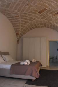 a bedroom with a bed with a stone ceiling at Corte Taddeo B&B in Galatina