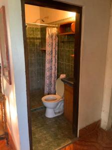 a bathroom with a toilet and a sink and a shower at La ballena cosmic las peñitas in Las Peñitas