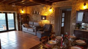 a living room with a couch and a table at Casa Madrilejo in Outes