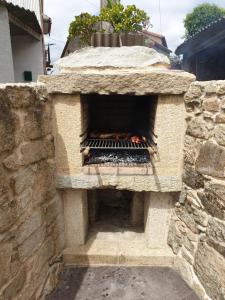 a stone oven with a fire inside of it at Casa Madrelejo in Outes