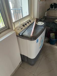 a wooden baseball bat sitting on top of a washing machine at 2BHKapartment-Calm and natural in Faridabad